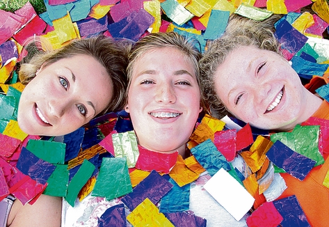 Garin College students Sjann Hungerford, Clare Sanders and Veronica Mitchell, 17, surrounded by the 5 Gum wrappers they are collecting for the schools arts festival. Photo: Sinead Ogilvie.