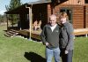 Steve Garnett and Tracey Lynch in front of a lodge on their property, close to where the fire started. Photo: Andrew Board.