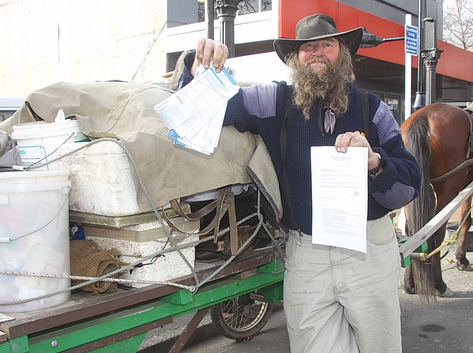 Lewis Stanton with some of his parking tickets and a summons to appear in court. Photo: Sinead Ogilvie.