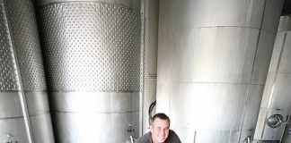 WINE SAVED: Waimea Estates general manager Ben Bolitho inspects a vat of 2014 pinot noir at the winery last week. Harvesting was completed just before last week’s big storm.